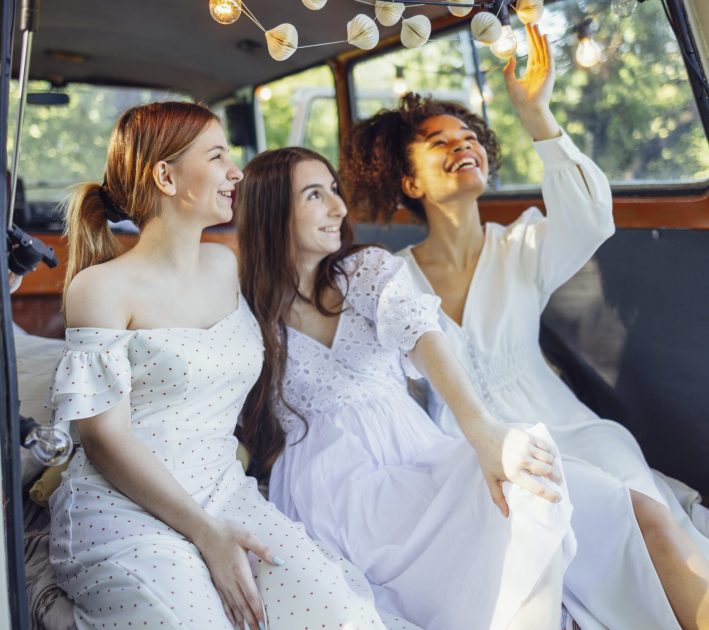 Three women celebrating together during a group day out